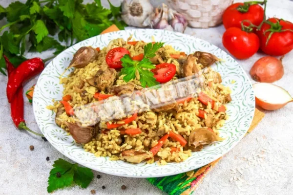 Розсипчастий плов з куркою на сковороді на плиті